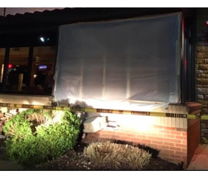 tarp over section of restaurant that was hit by a car 
