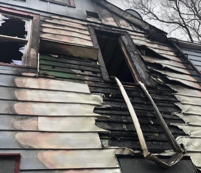siding and windows on front of house burned after fire