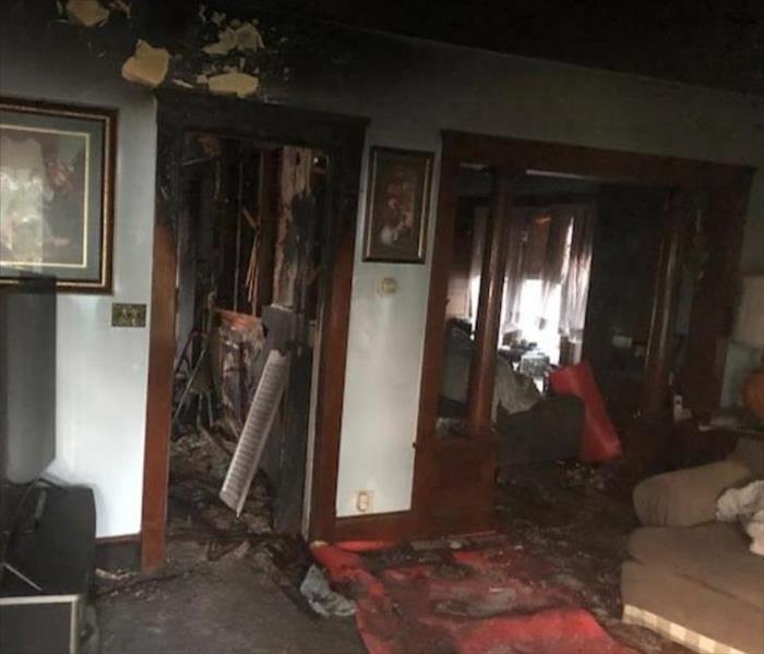 soot and fire damaged walls in living room