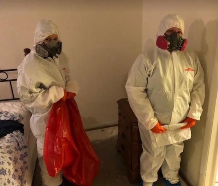 employees in ppe to clean biohazard